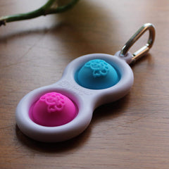 Fat Brain Toys Simpl Dimpl, Simple Dimple, Blue and Pink Popping Fidget Keychain, Sensory Toy for Kids Teens & Adults Ages 3 and Up