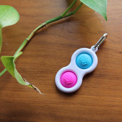 Fat Brain Toys Simpl Dimpl, Simple Dimple, Blue and Pink Popping Fidget Keychain, Sensory Toy for Kids Teens & Adults Ages 3 and Up